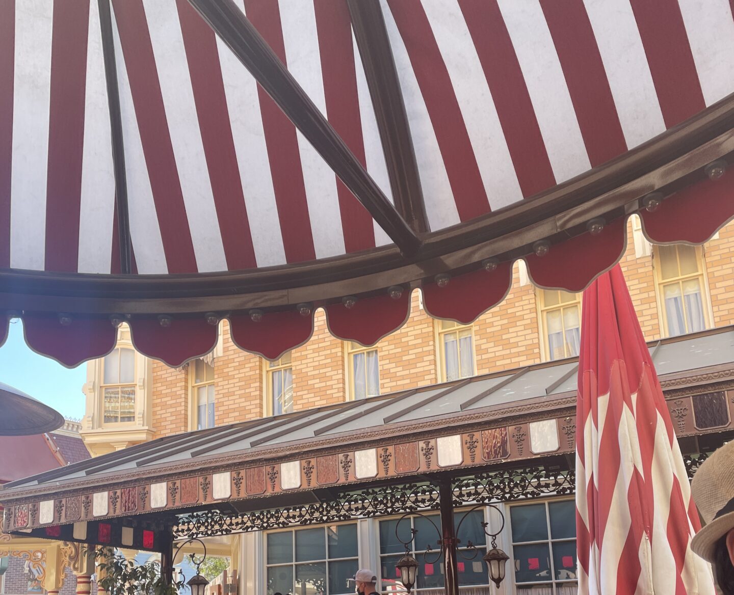 Dine under the candy striped umbrellas at Carnation Cafe in Disneyland